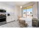 Bright kitchen with stainless steel appliances, dining area, and sliding glass doors to backyard at 5907 Soft Mist Ct, Las Vegas, NV 89110