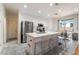 Bright kitchen with stainless steel appliances, center island with seating, and natural light at 5907 Soft Mist Ct, Las Vegas, NV 89110