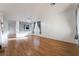 Bright living room with wood floors, neutral walls, and large windows with drapes at 5907 Soft Mist Ct, Las Vegas, NV 89110