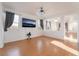 Bright living room with wood floors, neutral walls, and large windows with drapes at 5907 Soft Mist Ct, Las Vegas, NV 89110