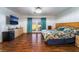 Large primary bedroom with wood floors, television, and access to the backyard at 5907 Soft Mist Ct, Las Vegas, NV 89110