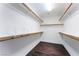 Bright walk-in closet with wood floors and shelving at 5907 Soft Mist Ct, Las Vegas, NV 89110