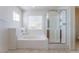 Bathroom with tub and separate glass shower at 5938 Village Loft St, North Las Vegas, NV 89081