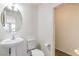 Modern bathroom featuring a pedestal sink and toilet at 5938 Village Loft St, North Las Vegas, NV 89081