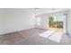 Light-filled bedroom with balcony access and neutral carpeting at 5938 Village Loft St, North Las Vegas, NV 89081