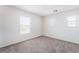 Bright bedroom features neutral carpet, white walls, and multiple windows offering natural light at 5938 Village Loft St, North Las Vegas, NV 89081