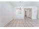 Clean dining room with tile flooring, bright lighting, and chandelier at 5938 Village Loft St, North Las Vegas, NV 89081