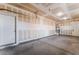 Spacious two-car garage with unfinished drywall, ample space and side door at 5938 Village Loft St, North Las Vegas, NV 89081