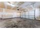Spacious two-car garage with unfinished drywall, ample space and overhead door at 5938 Village Loft St, North Las Vegas, NV 89081