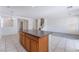 Bright kitchen with center island, tile floors, and chandelier lighting at 5938 Village Loft St, North Las Vegas, NV 89081