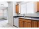 Clean kitchen features wooden cabinets and a window over the sink at 5938 Village Loft St, North Las Vegas, NV 89081