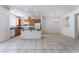 Kitchen with wooden cabinets, white appliances, tile floors, and adjacent dining area at 5938 Village Loft St, North Las Vegas, NV 89081