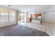 Open-concept living area featuring staircase, tile flooring, kitchen, and natural light at 5938 Village Loft St, North Las Vegas, NV 89081