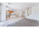 Open-concept living area featuring staircase, tile flooring, kitchen, and natural light at 5938 Village Loft St, North Las Vegas, NV 89081