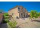 Backyard featuring a well maintained lawn, fire pit, and landscaping for outdoor enjoyment at 6429 Joshuaville Dr, Las Vegas, NV 89122