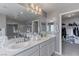 Bathroom featuring a dual sink vanity, well lit mirror, and closet access at 6429 Joshuaville Dr, Las Vegas, NV 89122