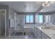 Modern bathroom with a glass-enclosed shower, soaking tub, and well-lit double vanity sinks at 6429 Joshuaville Dr, Las Vegas, NV 89122