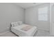 Minimalist bedroom featuring soft gray walls, a queen bed, and natural light at 6429 Joshuaville Dr, Las Vegas, NV 89122