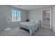 Well-lit bedroom with large window and carpeted floor; bathroom access adds to the room's appeal at 6429 Joshuaville Dr, Las Vegas, NV 89122