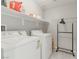 Functional laundry room with modern appliances, ample shelving, and neutral tones at 6429 Joshuaville Dr, Las Vegas, NV 89122