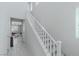 Bright stairway with white railing and tile flooring leading to the upper level at 6429 Joshuaville Dr, Las Vegas, NV 89122
