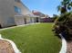 Lush, artificial turf backyard with covered patio, perfect for entertaining at 6608 Buried Treasure Ct, Las Vegas, NV 89139