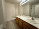 Bathroom with double sink vanity and tiled shower at 6608 Buried Treasure Ct, Las Vegas, NV 89139