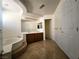 Bathroom with a soaking tub, double sink vanity, and tile flooring at 6608 Buried Treasure Ct, Las Vegas, NV 89139