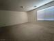 Empty bedroom with carpet flooring, a window and neutral wall color at 6608 Buried Treasure Ct, Las Vegas, NV 89139
