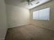 Neutral bedroom with carpet, a ceiling fan, and a window at 6608 Buried Treasure Ct, Las Vegas, NV 89139