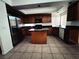 A functional kitchen with stainless steel refrigerator, center island, and tile flooring at 6608 Buried Treasure Ct, Las Vegas, NV 89139
