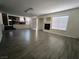 Spacious living room with modern flooring, a fireplace, and an adjacent kitchen area at 6608 Buried Treasure Ct, Las Vegas, NV 89139