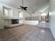 A spacious living room features tile floors, a fireplace, and open access to stairs at 6608 Buried Treasure Ct, Las Vegas, NV 89139