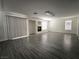 Expansive living room featuring modern flooring, a cozy fireplace, and bright, neutral paint at 6608 Buried Treasure Ct, Las Vegas, NV 89139
