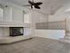 Spacious living room with fireplace, vaulted ceiling, tile floors, and plenty of natural light at 6608 Buried Treasure Ct, Las Vegas, NV 89139