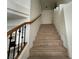 Carpeted staircase with wood and iron railing leading to the upper level at 6608 Buried Treasure Ct, Las Vegas, NV 89139
