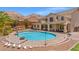 Spacious backyard with a large pool, spa, brick patio, and mountain views at 6958 Lazy Sunset Ct, Las Vegas, NV 89156