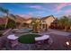 An expansive backyard with a manicured lawn, pool, statue and a charming gazebo, perfect for outdoor gatherings at 6958 Lazy Sunset Ct, Las Vegas, NV 89156