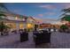 Spacious backyard patio featuring comfortable seating around an outdoor fireplace, ideal for evening gatherings at 6958 Lazy Sunset Ct, Las Vegas, NV 89156