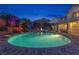 Lush landscaping surrounds a backyard pool and patio area, perfect for outdoor entertaining at 6958 Lazy Sunset Ct, Las Vegas, NV 89156