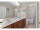 Bathroom with a double sink vanity, large mirror, and separate toilet and shower area at 6958 Lazy Sunset Ct, Las Vegas, NV 89156
