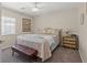 Charming bedroom with neutral walls, plush bedding, bench seating, and framed artwork at 6958 Lazy Sunset Ct, Las Vegas, NV 89156
