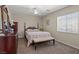 Bright bedroom featuring a ceiling fan, neutral walls, ample natural light, and cozy bench seating at 6958 Lazy Sunset Ct, Las Vegas, NV 89156