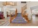 Spacious foyer showcases a staircase with wooden banisters and views of the dining and living areas at 6958 Lazy Sunset Ct, Las Vegas, NV 89156