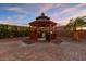 An alluring backyard gazebo with a grill situated on a brick-paved lot at 6958 Lazy Sunset Ct, Las Vegas, NV 89156