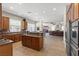 Open kitchen featuring a large island with granite countertops and stainless steel appliances at 6958 Lazy Sunset Ct, Las Vegas, NV 89156