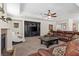Comfortable living room with a fireplace, media center, and plush seating at 6958 Lazy Sunset Ct, Las Vegas, NV 89156