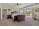 Spacious bedroom with a sliding glass door to the outside, ceiling fan, and bedroom furniture at 6958 Lazy Sunset Ct, Las Vegas, NV 89156