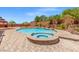Inviting backyard pool and spa surrounded by lush landscaping, perfect for relaxation and entertainment at 6958 Lazy Sunset Ct, Las Vegas, NV 89156