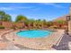 Backyard pool and spa with a large brick patio and desert landscaping at 6958 Lazy Sunset Ct, Las Vegas, NV 89156